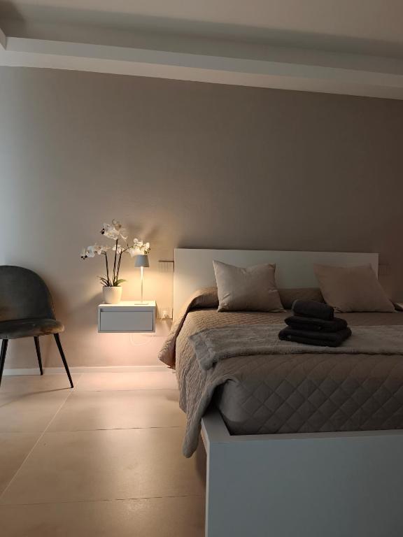a bedroom with a bed and a table and a chair at Sole Relax Pula in Pula