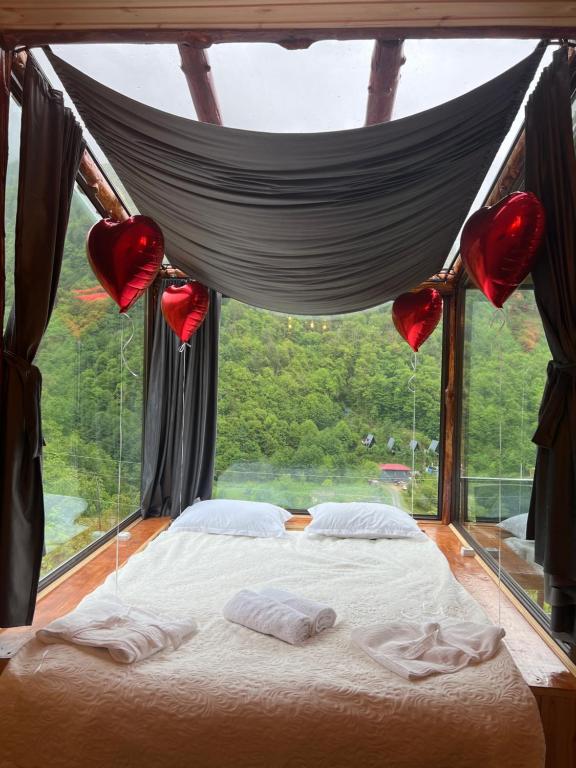 a bed in a room with a large window at Mountain Paradise in Merisi 2 in Merisi