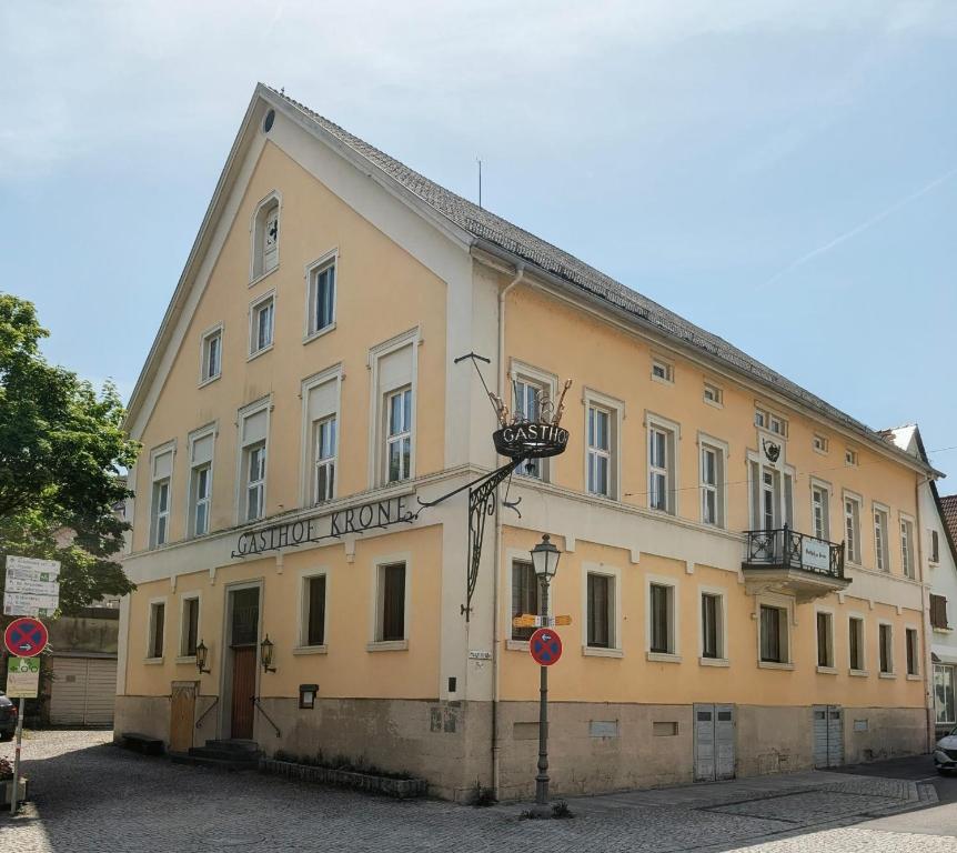 a large yellow building with a street light in front of it at Serviced Rooms ''Krone'' in Creglingen