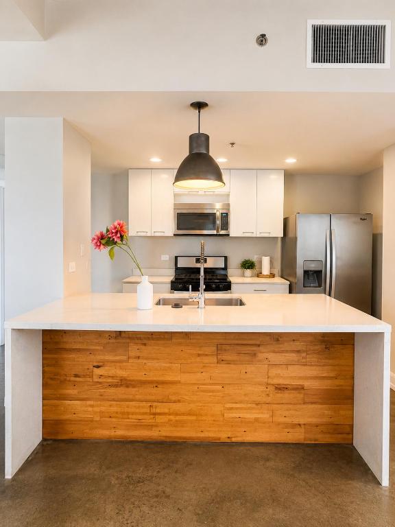 a kitchen with a large wooden island in the middle at The Haven Loft in Birmingham