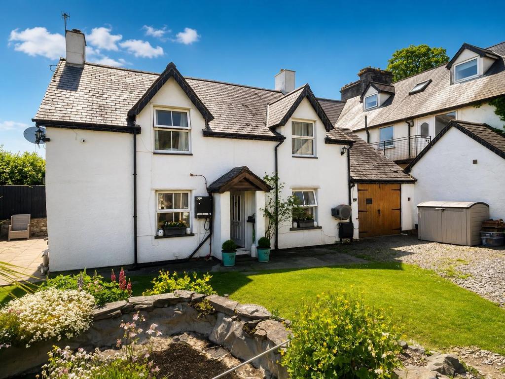 a large white house with a yard at The Old Smithy in Trefriw