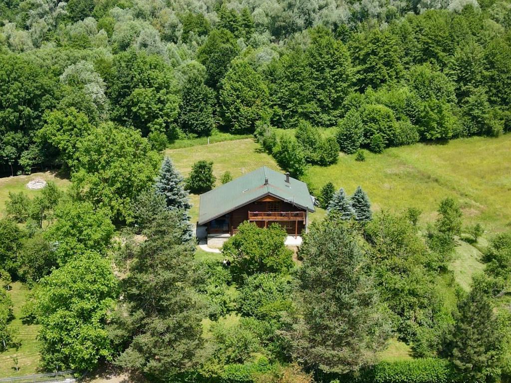 an aerial view of a house on a hill with trees at Pine River Dobrenica in Bihać