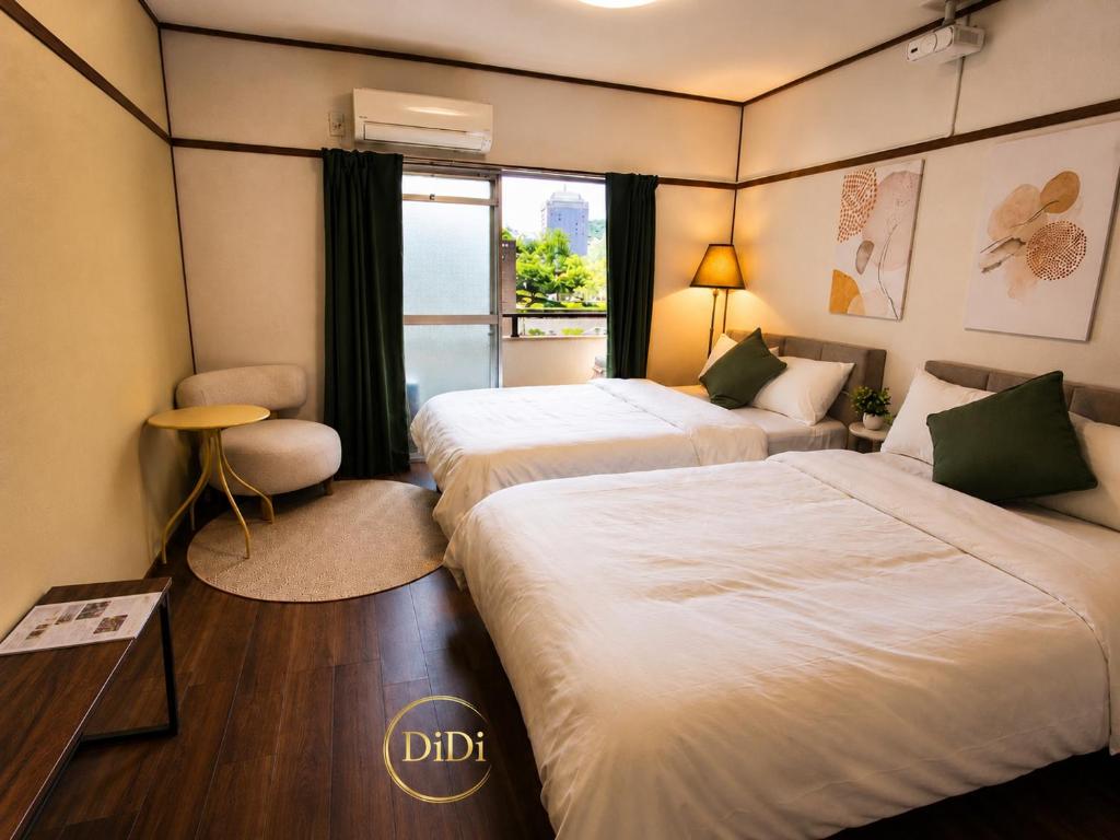 a hotel room with two beds and a window at 徳島駅徒歩10分 公園前 Netflix DiDi Base 203 in Tokushima