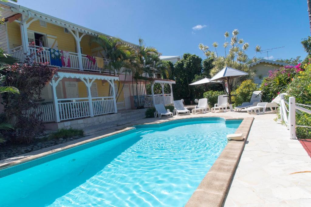 a swimming pool in front of a house at L'escapade in Sainte-Anne