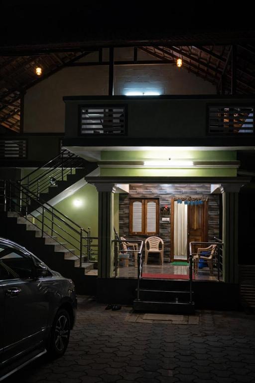 a house at night with a car parked in front at Gramasiri Homestay in Sringeri