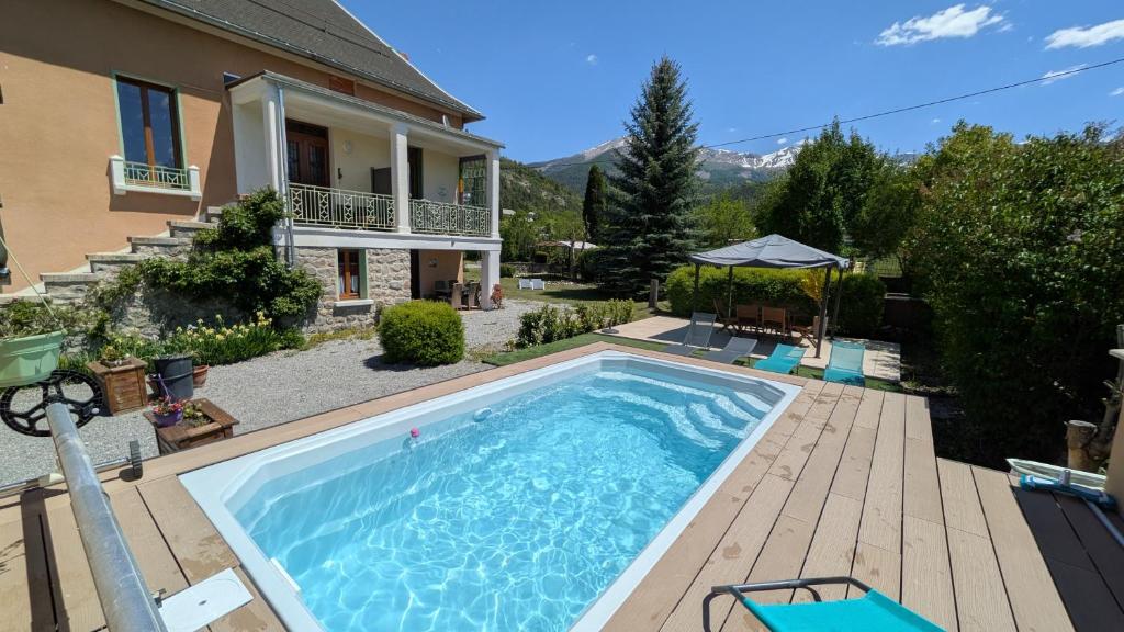 a swimming pool in the backyard of a house at Chambre d'Hotes La Mexicaine in Jausiers