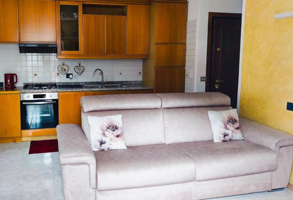 a living room with a couch in a kitchen at NicoMeli Home in Dimaro