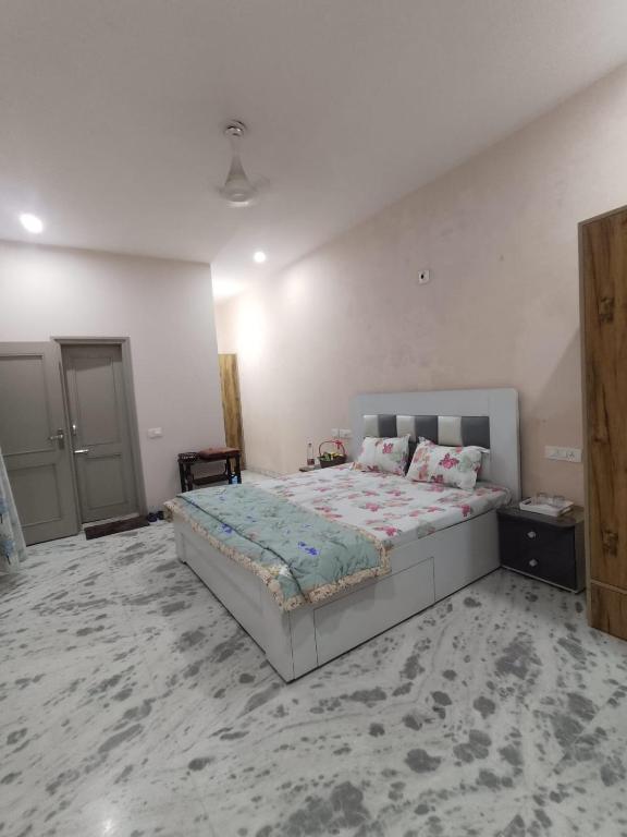 a bedroom with a large bed in a room at Om Homestay in Panchkula
