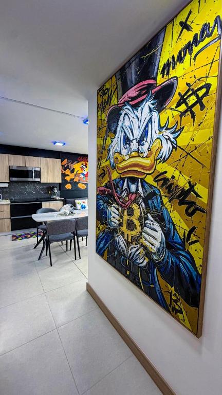 a painting on a wall in a room with at Luxury Condo at Live Jaco Tower in Jacó