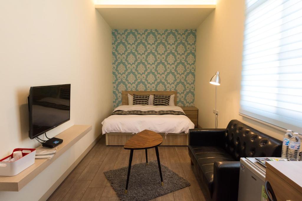 Postel nebo postele na pokoji v ubytování Tainan Sweet Home