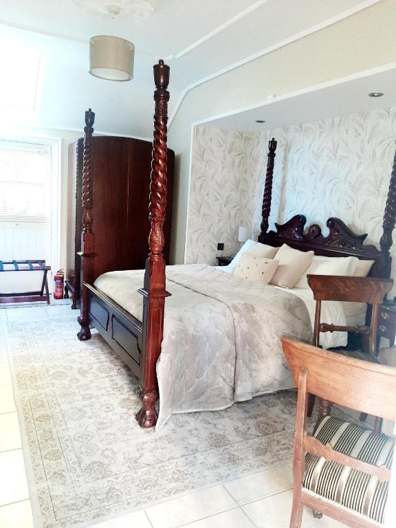 a bedroom with a large bed with a wooden headboard at Riverside Lodge in Carlingford