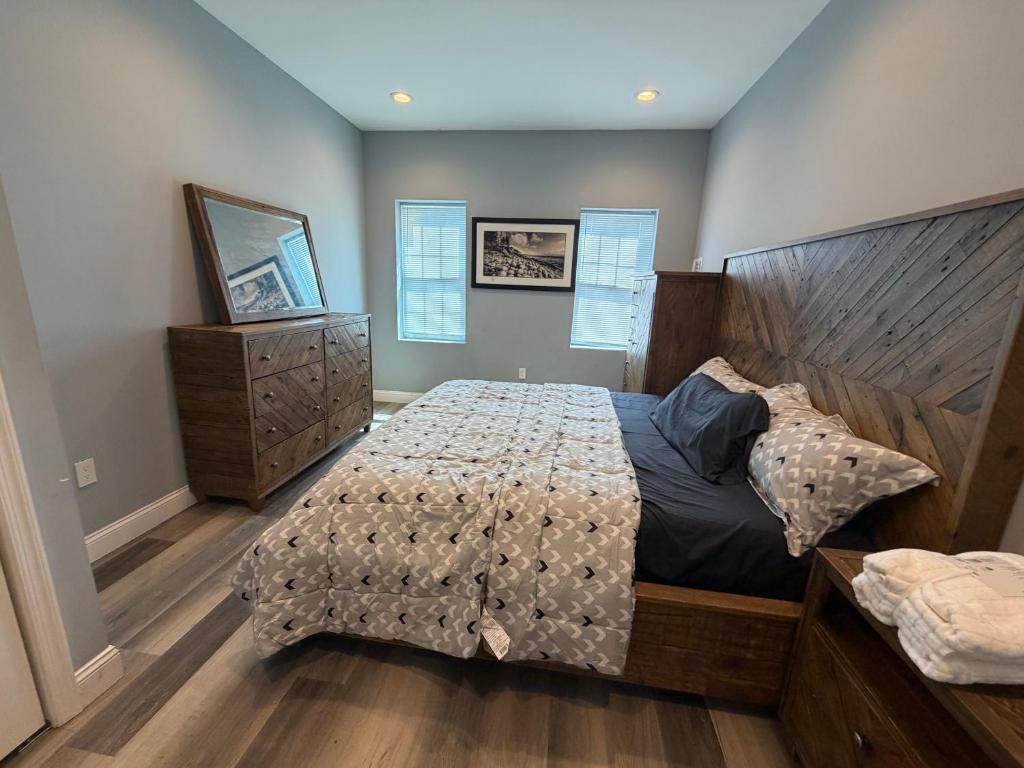 a bedroom with a large bed with a wooden headboard at Ben house in Baltimore