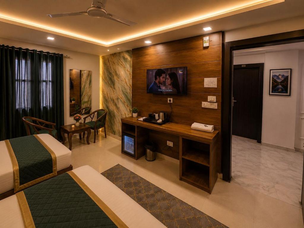 a hotel room with a bed and a desk at Hotel Bellamontan Suites Near Delhi Airport - Free Airport Pickup & Drop in New Delhi
