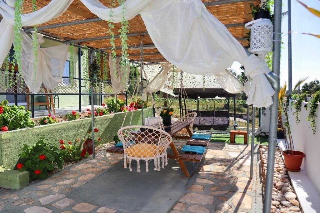 a patio with a table and chairs under a pergola at La Rosalie in Astris