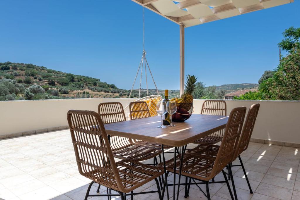a wooden table and chairs on a patio at Stone Cottage in Morónion