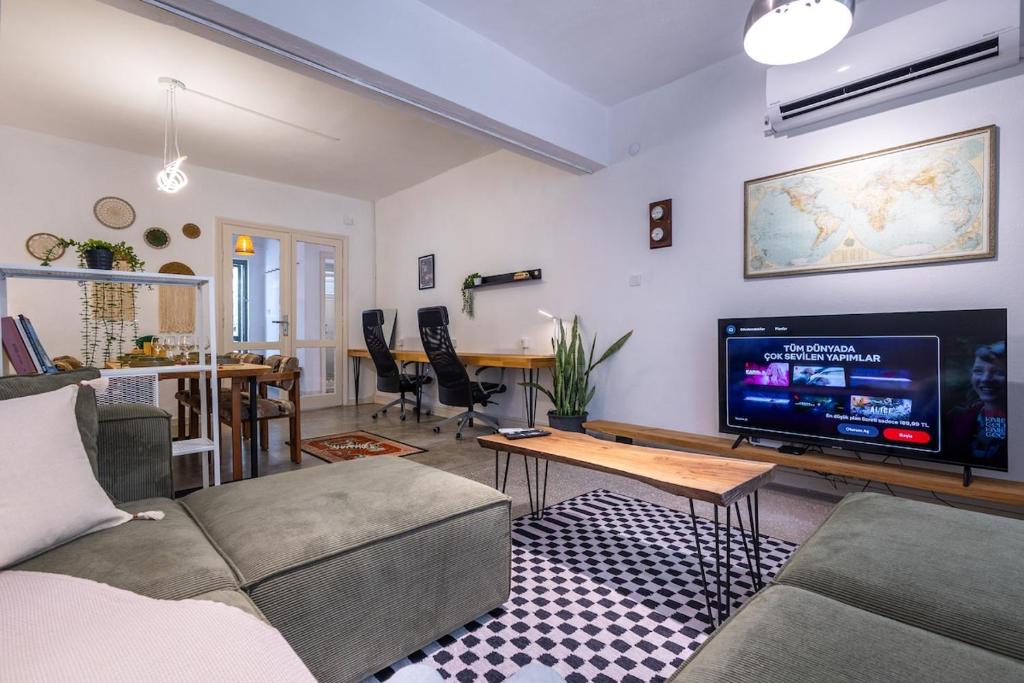 a living room with a couch and a tv at 7a old Marmaris house in Marmaris