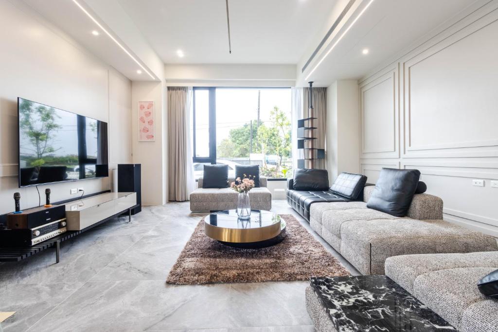 a living room with a couch and a tv at ZJ Villa in Sanxing