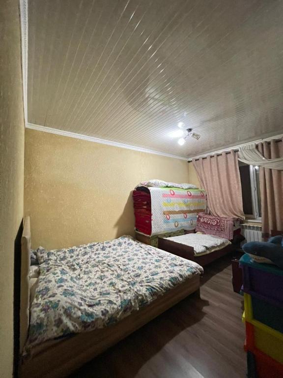 a bedroom with two beds in a room at Arlanguesthouse in Dzhangyaryk