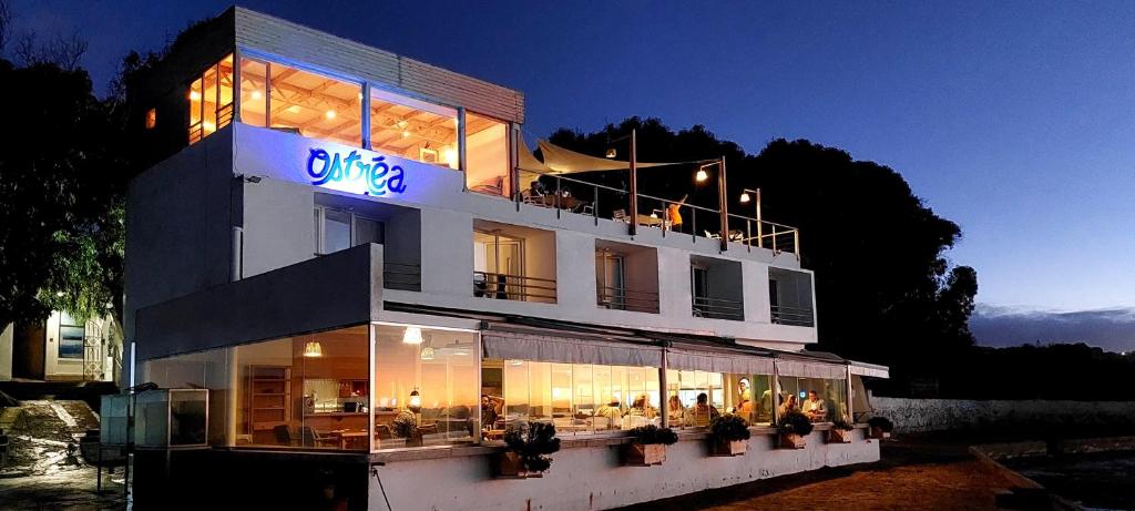 a large building with people sitting on the balcony at Ostrea - Lagune de Oualidia in Oualidia