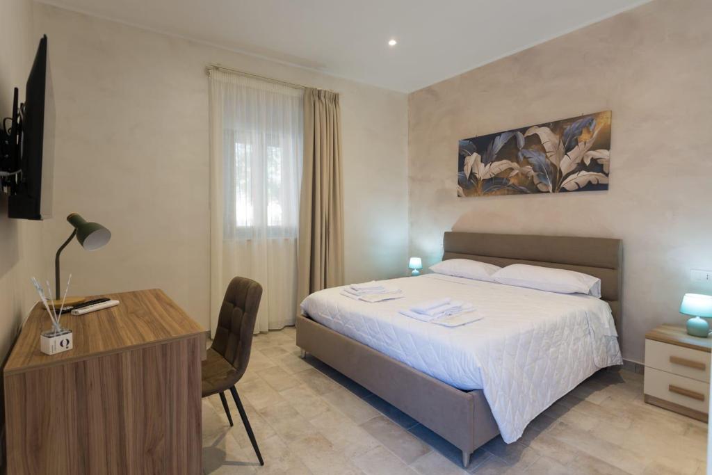 a bedroom with a bed and a desk and a bed sidx sidx sidx at Antica Dimora Ceri in Ceri