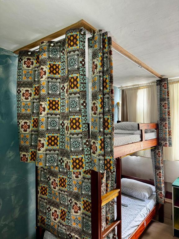 a bedroom with two bunk beds with a quilt at Hostel New Ipanema in Rio de Janeiro