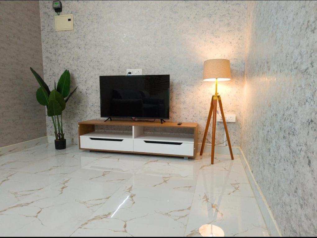 a living room with a flat screen tv on a entertainment center at HideAway in Hyderabad