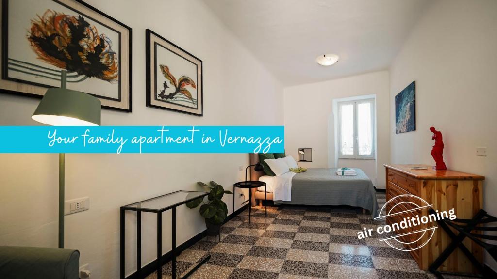 a bedroom with a bed and a sign on the wall at La Casa del Pastenello Family Apartment with AC in Vernazza