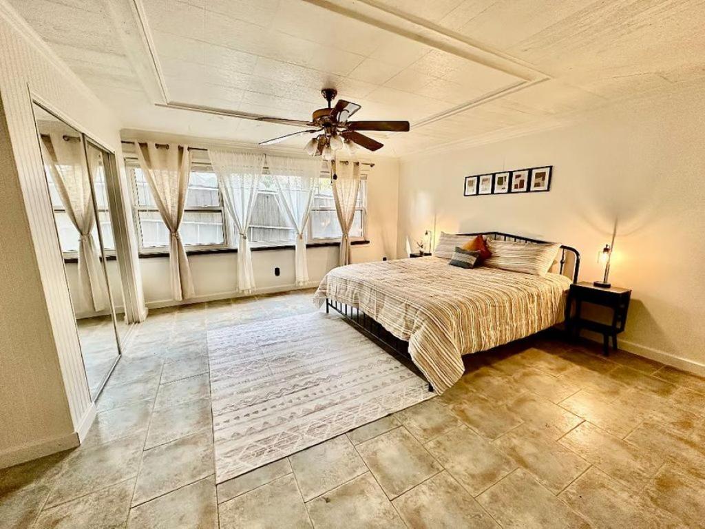 a bedroom with a bed and a ceiling fan at Newly Renovated Quiant 2-bed 2-bath Apt in Wilmington