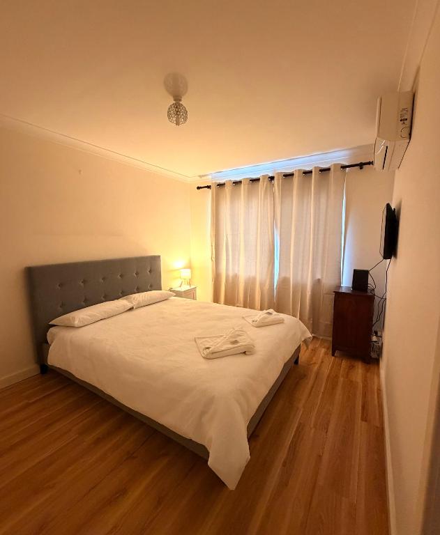 a bedroom with a large bed with a wooden floor at Fleur de Collie in Collie