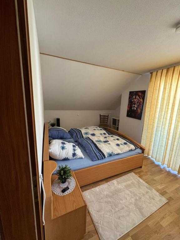 a small bedroom with a bed and a table at Spessartblick in Heimbuchenthal