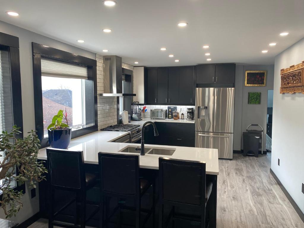 a kitchen with a sink and a refrigerator at The Station House in Brantford