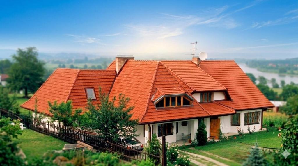 a house with an orange roof on a hill at Dunajec Mansion in Czchów