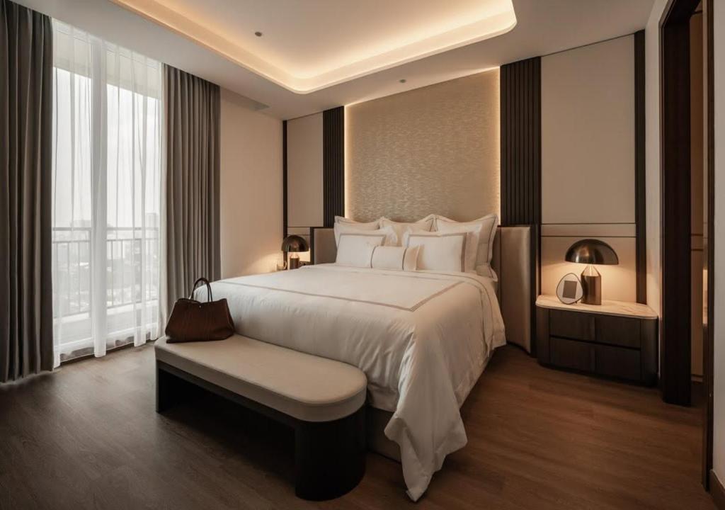 a large bedroom with a large bed and a window at FairMounts Plaza Inns Near Delhi International Airport in New Delhi