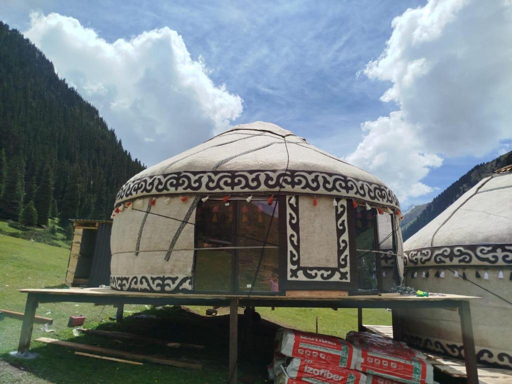 a large yurt is sitting in a field at Kyrgyz Yurt Camp in Mineralʼnyy Istochnik Altyn-Arasan