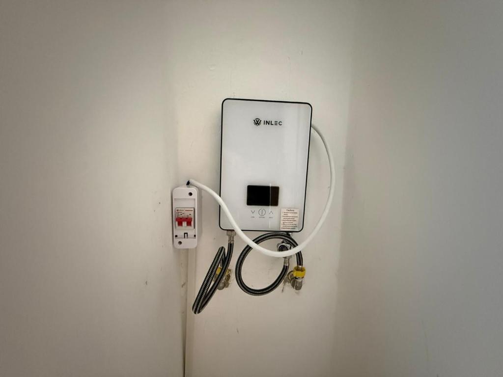 a wall with a white outlet with a cord plugged into it at Cange in Albana