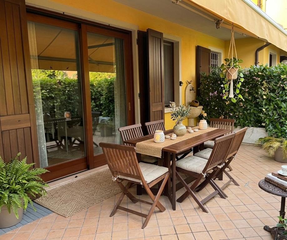 a wooden table and chairs on a patio at Azzurro Garda in Sirmione