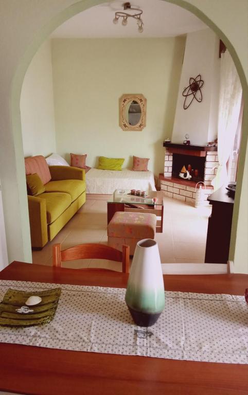 a living room with a couch and a table at Catherine Seaside Apartment in Ouranoupoli