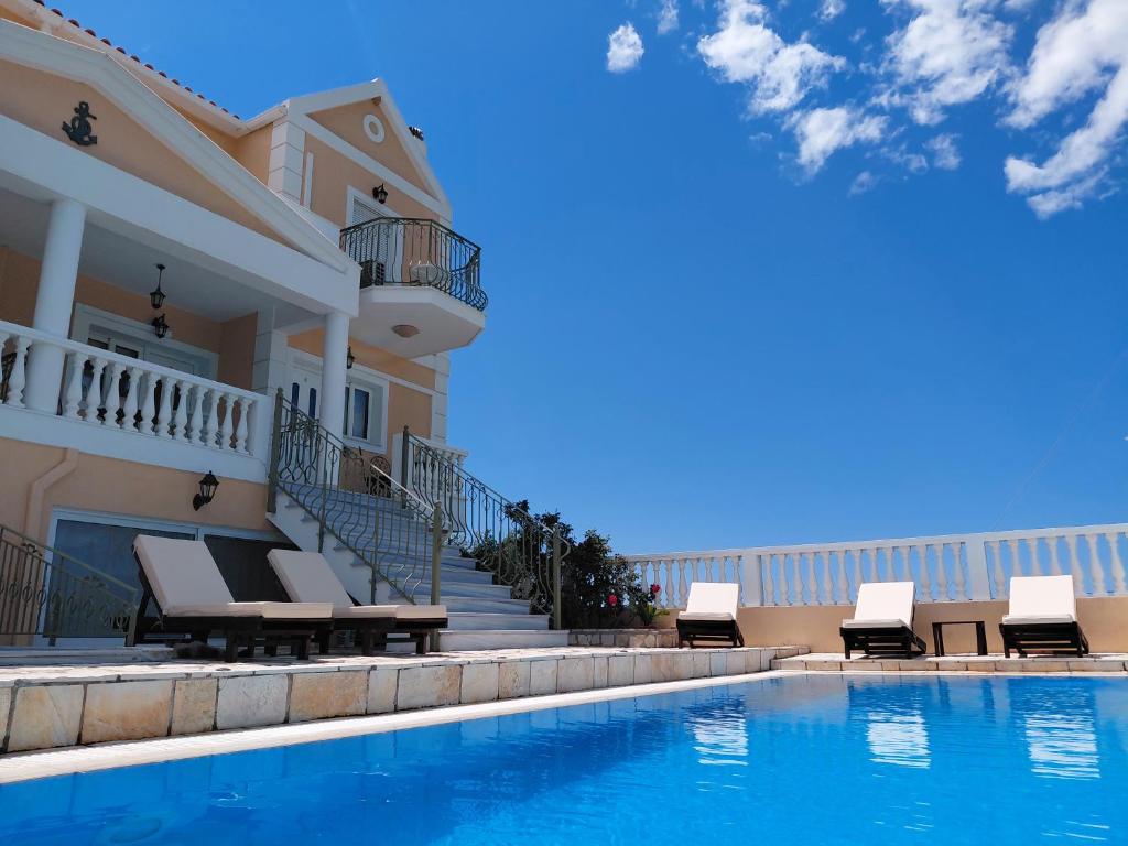 a villa with a swimming pool and a house at Irini's Villa in Argostoli