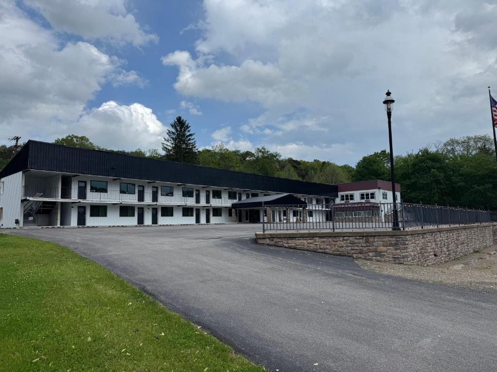 a large white building with a black roof at Raystown Country Lodge in Huntingdon