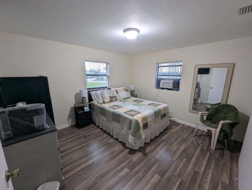 a bedroom with a bed and a mirror in it at Small Town Florida in Jensen Beach