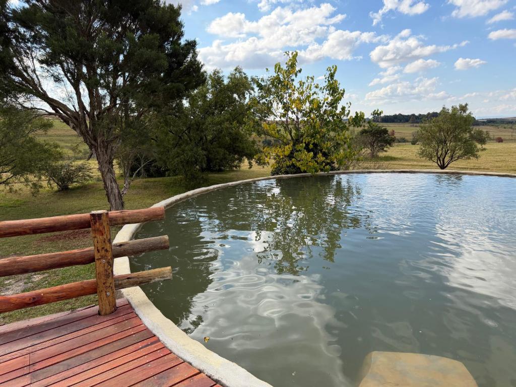 a pool of water with a fence around it at Tranquility Campsite in Winterton