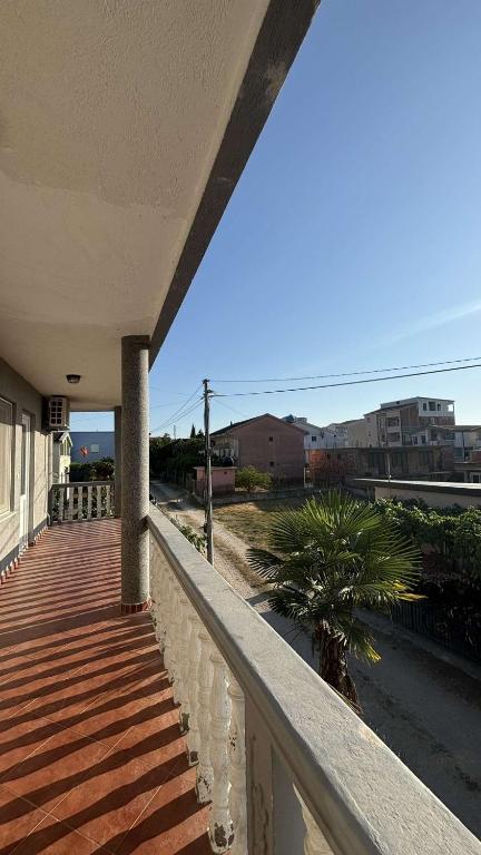 a balcony of a house with a palm tree on it at Appartemani EMIE in Donji Štoj