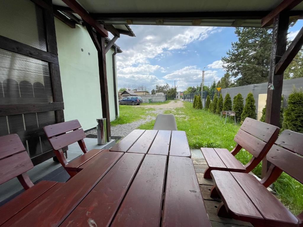 a wooden picnic table on the porch of a house at Na Papierni in Klucze