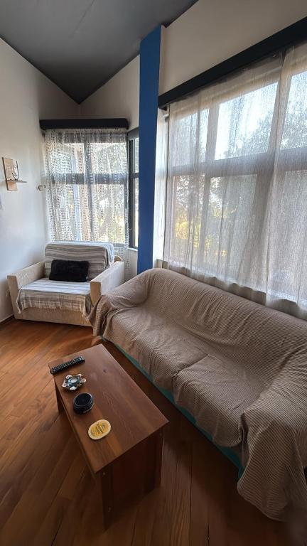 a living room with a couch and a coffee table at Blue Note in Mytilene