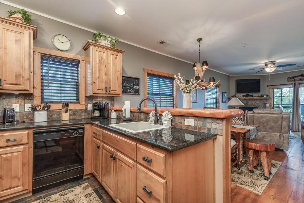 a kitchen with wooden cabinets and a counter top at 2BR Village At Indian Point 501 near SDC-Free Tickets Daily up to $500 in Branson