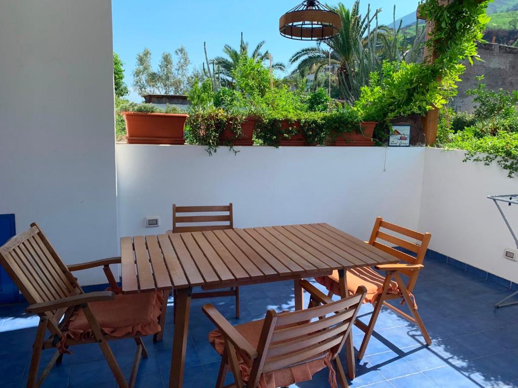 a wooden table and chairs on a patio at Il Vulcano a Piedi in Stromboli