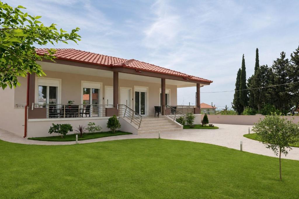 a house with a green lawn in front of it at Pella Luxury Archonta in Pélla