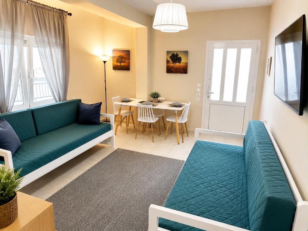 a living room with a couch and a table at Anna’s house in Síndos