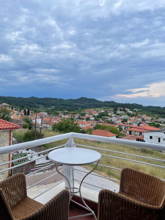 a balcony with a table and chairs and a view at Blue House 2 in Paliouri