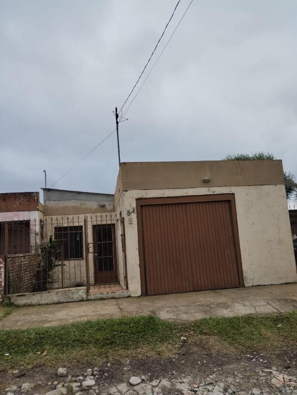 a house with two garage doors in front of it at Casa da JEANI CLEIDI in Rosário do Sul